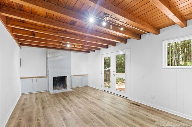1814 Sunnyside Cir, Fayetteville, NC 28305 - unfurnished living room featuring light wood-style flooring, a wood ceiling with exposed beams, healthy amount of natural light, a brick fireplace, and french doors