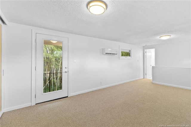 1814 Sunnyside Cir, Fayetteville, NC 28305 - spare room featuring a textured ceiling, a wall mounted air conditioner, and carpet flooring