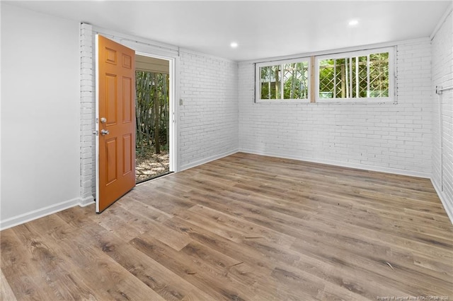 1814 Sunnyside Cir, Fayetteville, NC 28305 - spare room with brick wall, wood finished floors, and recessed lighting