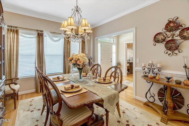 1421 Hopson Downs Ct, Holly Springs, NC 27540 - dining area featuring a chandelier, light wood finished floors, and ornamental molding
