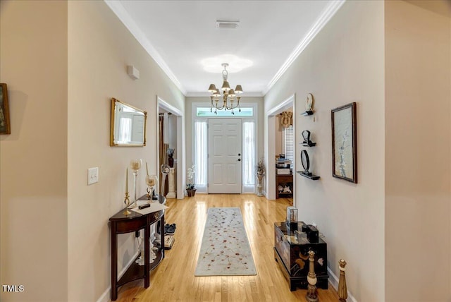 1421 Hopson Downs Ct, Holly Springs, NC 27540 - entrance foyer with a chandelier, ornamental molding, and light wood-type flooring