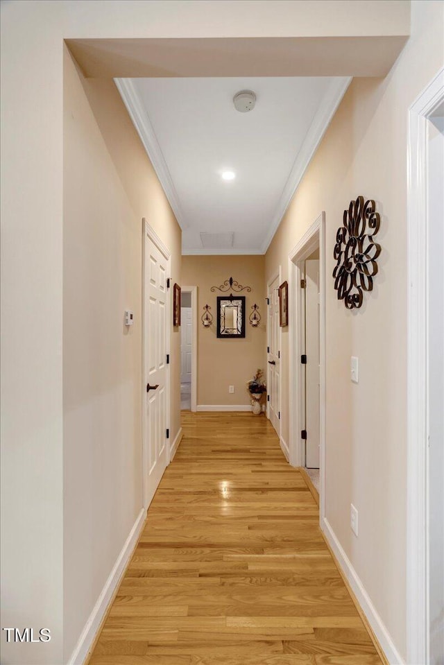 1421 Hopson Downs Ct, Holly Springs, NC 27540 - hallway with ornamental molding and light wood finished floors
