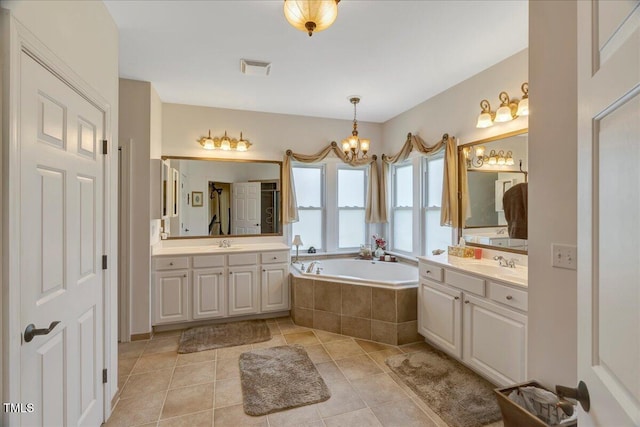 1421 Hopson Downs Ct, Holly Springs, NC 27540 - full bath with a chandelier, a garden tub, two vanities, and tile patterned floors