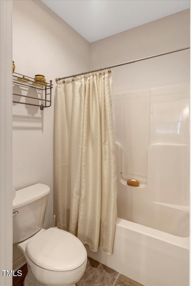 1421 Hopson Downs Ct, Holly Springs, NC 27540 - bathroom featuring shower / bathtub combination with curtain and toilet