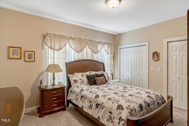1421 Hopson Downs Ct, Holly Springs, NC 27540 - carpeted bedroom featuring baseboards and two closets
