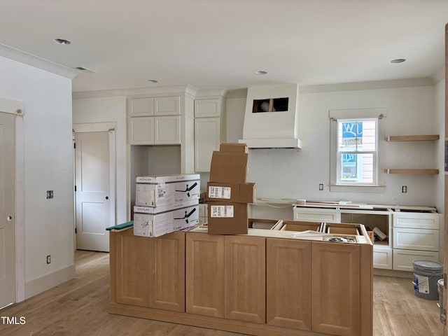 2658 Lawndale Ave, Durham, NC 27705 - kitchen with a kitchen island, light wood-style floors, open shelves, custom exhaust hood, and white cabinets