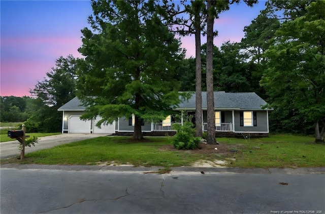 806 Eagle Landing Dr, Hope Mills, NC 28348 - view of front facade with a porch, concrete driveway, a front lawn, and a garage