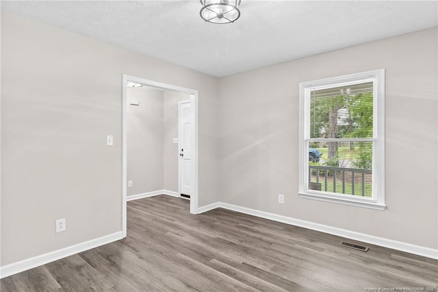 806 Eagle Landing Dr, Hope Mills, NC 28348 - spare room with wood finished floors and a textured ceiling