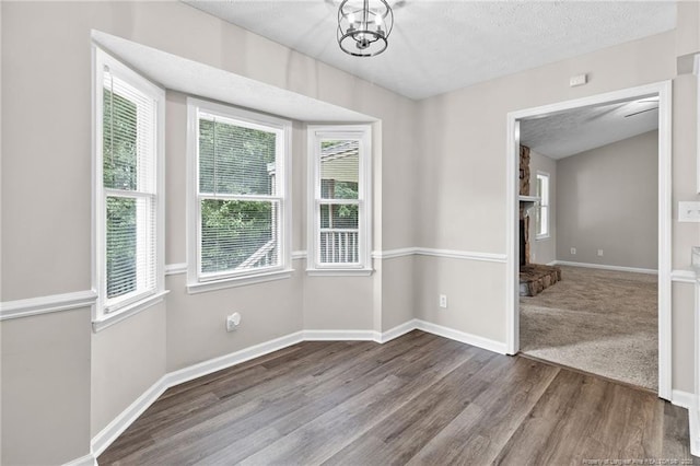 806 Eagle Landing Dr, Hope Mills, NC 28348 - spare room with plenty of natural light, wood finished floors, a textured ceiling, and a chandelier