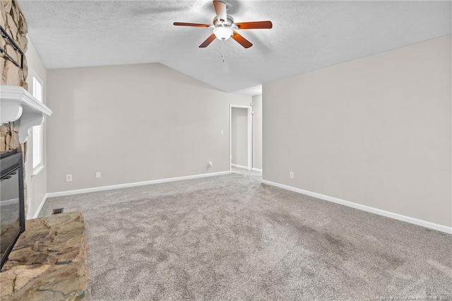 806 Eagle Landing Dr, Hope Mills, NC 28348 - unfurnished living room with a stone fireplace, a ceiling fan, a textured ceiling, carpet, and lofted ceiling
