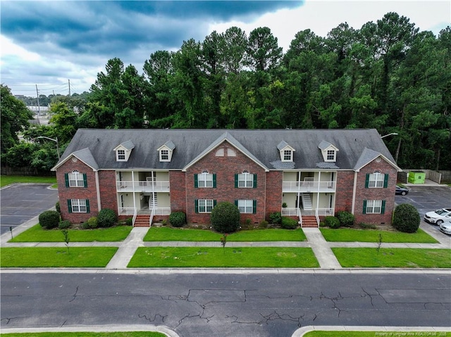 3401 Lainey Ln Unit D, Fayetteville, NC 28314 - view of front of property featuring brick siding, a balcony, and a front yard