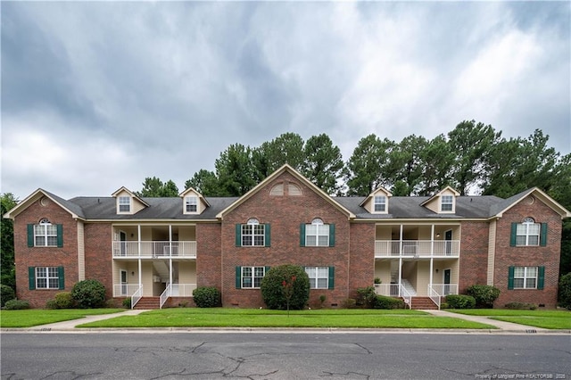 3401 Lainey Ln Unit D, Fayetteville, NC 28314 - view of front facade with a balcony, brick siding, and covered porch