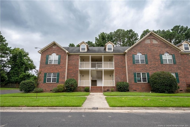 3401 Lainey Ln Unit D, Fayetteville, NC 28314 - view of front facade with crawl space, brick siding, a balcony, covered porch, and a front lawn