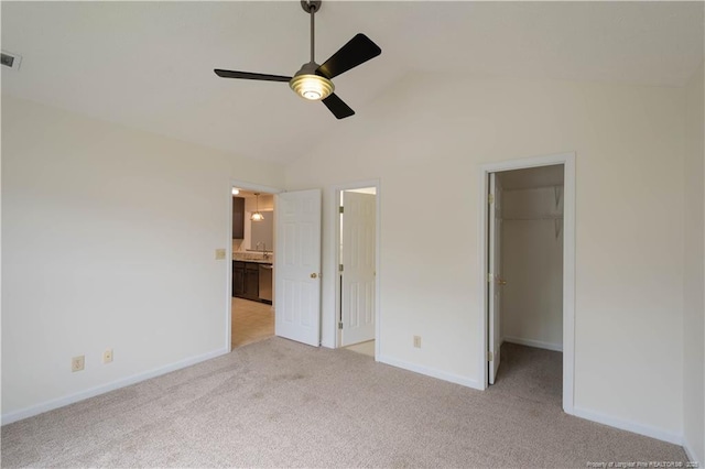3401 Lainey Ln Unit D, Fayetteville, NC 28314 - unfurnished bedroom with a spacious closet, light carpet, lofted ceiling, ensuite bathroom, and a ceiling fan