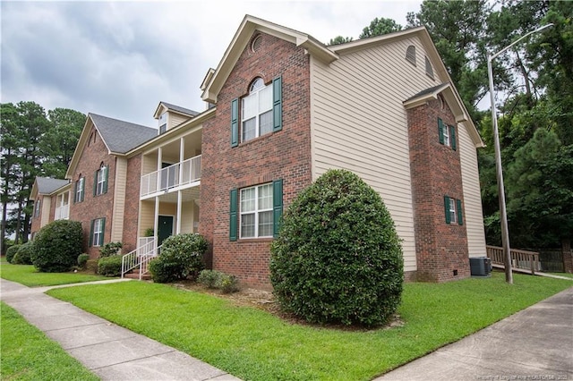 3401 Lainey Ln Unit D, Fayetteville, NC 28314 - view of side of property featuring brick siding, a balcony, and a lawn