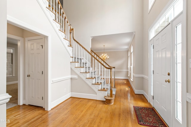 2464 Village Of Wakefield Dr, Zebulon, NC 27597 - entrance foyer featuring stairway, light wood finished floors, a towering ceiling, and a chandelier