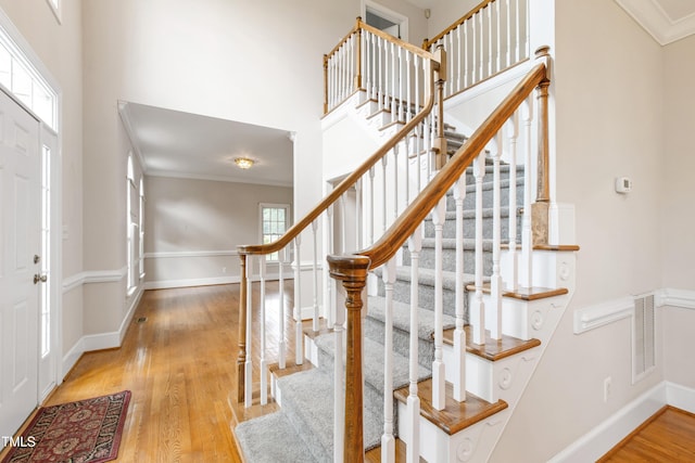2464 Village Of Wakefield Dr, Zebulon, NC 27597 - entryway featuring light wood-type flooring, stairway, crown molding, and a high ceiling