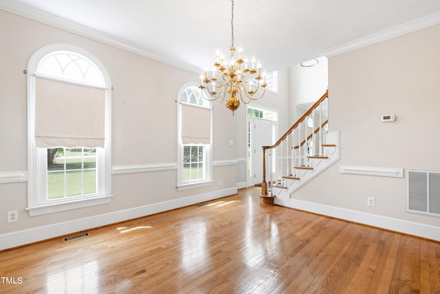 2464 Village Of Wakefield Dr, Zebulon, NC 27597 - entryway featuring a chandelier, wood finished floors, crown molding, and stairs