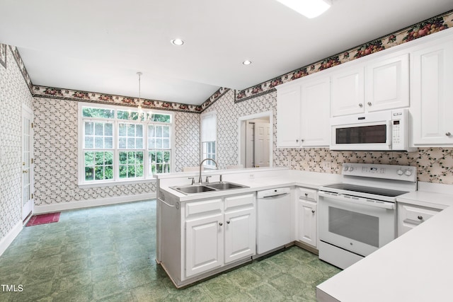 2464 Village Of Wakefield Dr, Zebulon, NC 27597 - kitchen with white appliances, wallpapered walls, white cabinetry, light flooring, and light countertops