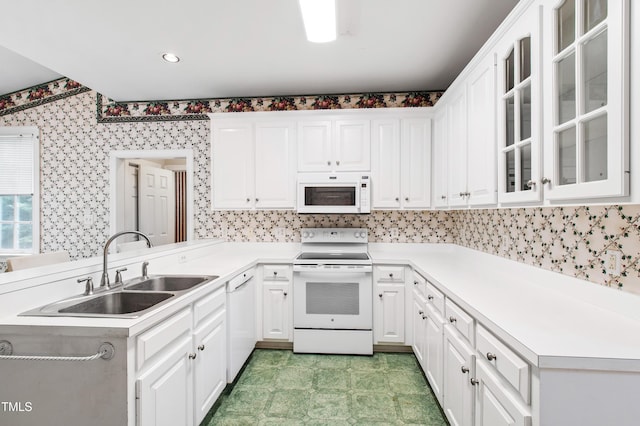 2464 Village Of Wakefield Dr, Zebulon, NC 27597 - kitchen with white appliances, a peninsula, light flooring, white cabinets, and wallpapered walls