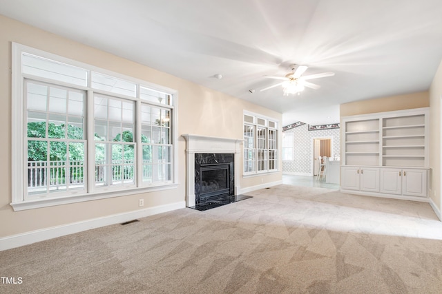 2464 Village Of Wakefield Dr, Zebulon, NC 27597 - unfurnished living room featuring carpet flooring, a ceiling fan, and a fireplace