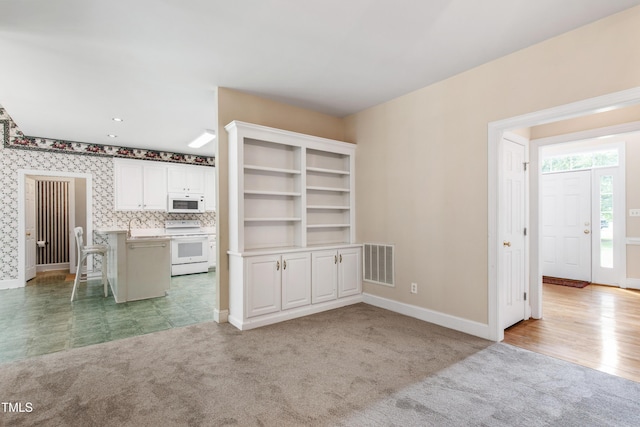 2464 Village Of Wakefield Dr, Zebulon, NC 27597 - unfurnished dining area with baseboards and light colored carpet