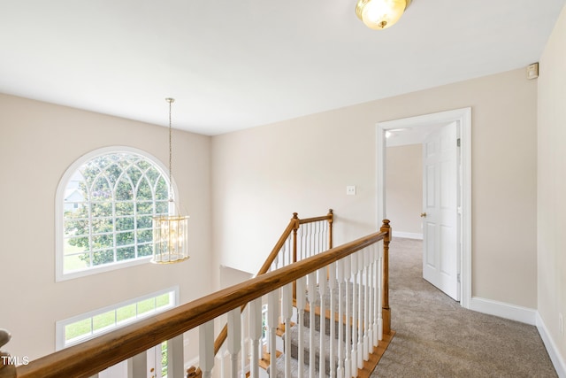 2464 Village Of Wakefield Dr, Zebulon, NC 27597 - hall featuring an upstairs landing, carpet flooring, and a chandelier