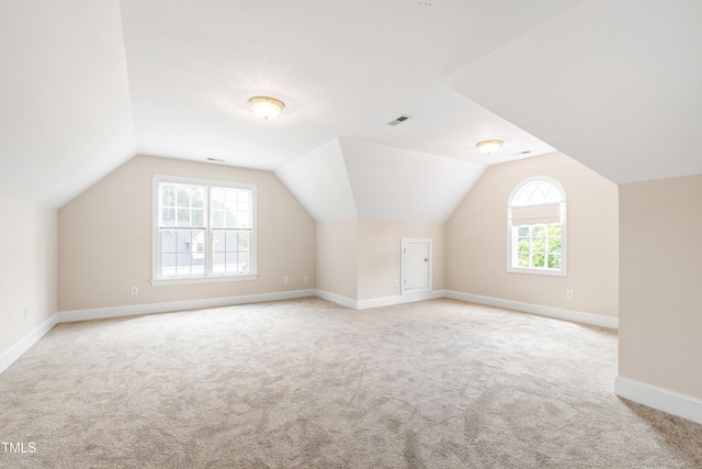 2464 Village Of Wakefield Dr, Zebulon, NC 27597 - additional living space featuring light carpet and vaulted ceiling