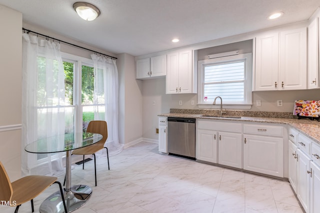 104 Silver Fox Ct, Cary, NC 27511 - kitchen with stainless steel dishwasher, light marble finish flooring, light stone counters, white cabinets, and healthy amount of natural light