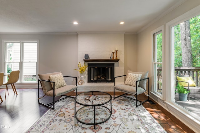 104 Silver Fox Ct, Cary, NC 27511 - living room with healthy amount of natural light, wood-type flooring, a brick fireplace, ornamental molding, and recessed lighting