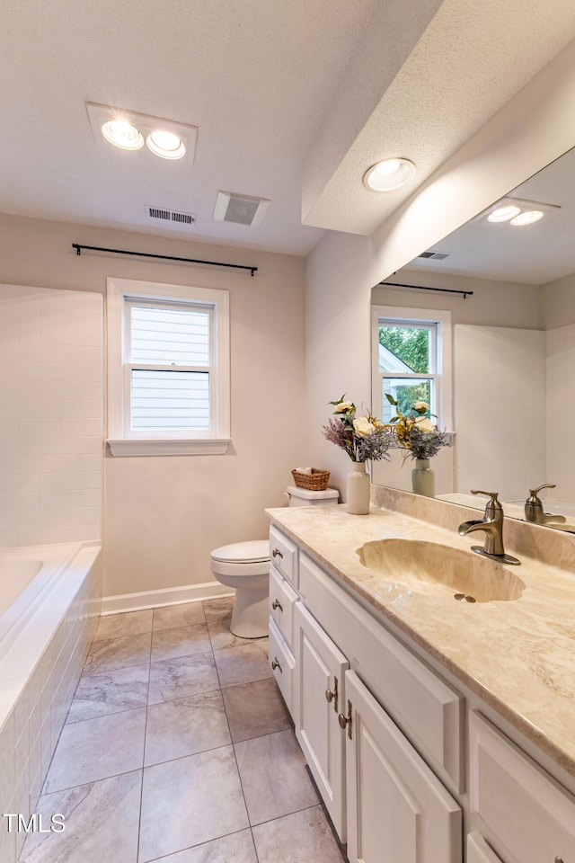 104 Silver Fox Ct, Cary, NC 27511 - bathroom with vanity and tiled bath