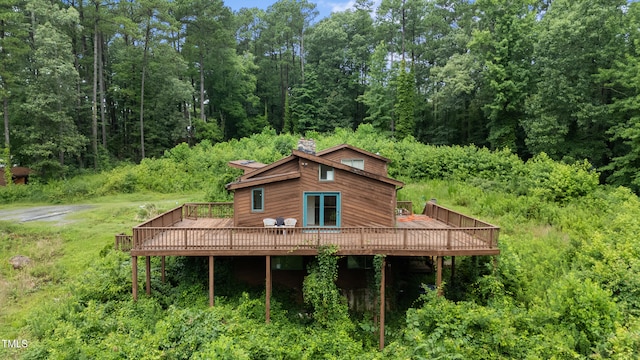1310 Martin Luther King Pkwy, Durham, NC 27707 - rear view of house featuring a deck, a chimney, and a view of trees
