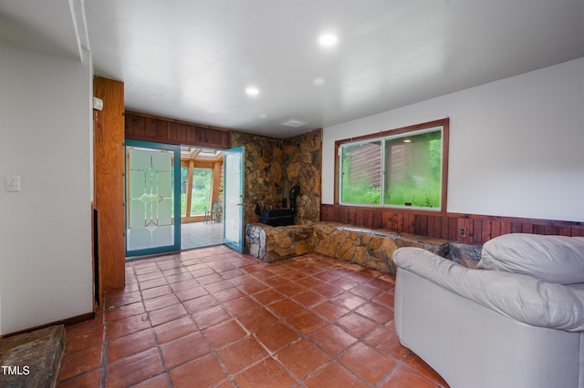 1310 Martin Luther King Pkwy, Durham, NC 27707 - living area featuring wood walls, a wood stove, recessed lighting, wainscoting, and tile patterned floors