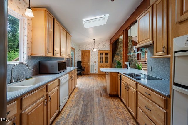 1310 Martin Luther King Pkwy, Durham, NC 27707 - kitchen featuring white appliances, wallpapered walls, hardwood / wood-style flooring, a skylight, and vaulted ceiling
