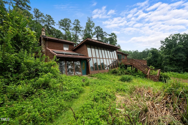 1310 Martin Luther King Pkwy, Durham, NC 27707 - rear view of house with stairway, a chimney, a sunroom, and a wooden deck