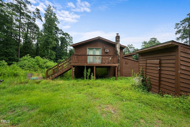 1310 Martin Luther King Pkwy, Durham, NC 27707 - rear view of property featuring a wooden deck, a chimney, stairs, and an outbuilding