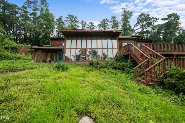 1310 Martin Luther King Pkwy, Durham, NC 27707 - back of property featuring a sunroom, stairs, and a wooden deck