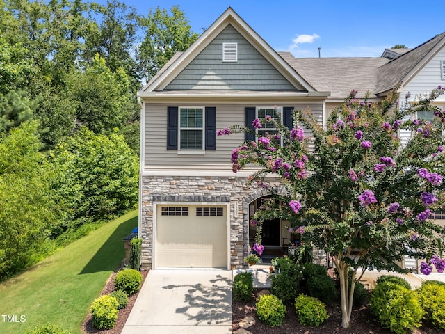 3801 Windsnap Dr, Wake Forest, NC 27587 - craftsman-style home with stone siding, a garage, concrete driveway, and a front yard