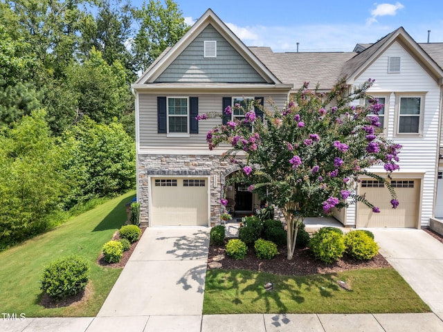 3801 Windsnap Dr, Wake Forest, NC 27587 - craftsman-style house with an attached garage, concrete driveway, stone siding, and a front yard