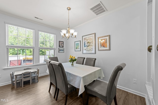 3801 Windsnap Dr, Wake Forest, NC 27587 - dining area featuring crown molding, a chandelier, and wood finished floors