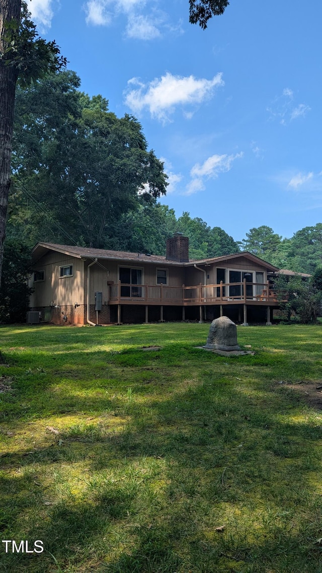 11636 Appaloosa Run W, Raleigh, NC 27613 - rear view of property with a lawn, a chimney, and a deck