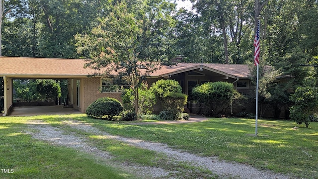 11636 Appaloosa Run W, Raleigh, NC 27613 - view of front facade with driveway, brick siding, a front yard, and an attached carport