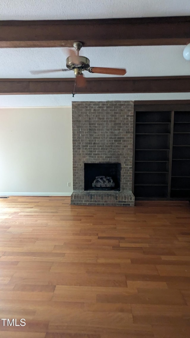 11636 Appaloosa Run W, Raleigh, NC 27613 - unfurnished living room with wood finished floors and a fireplace
