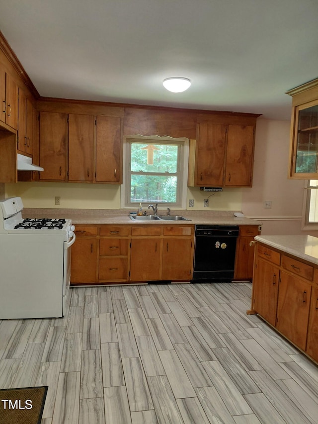11636 Appaloosa Run W, Raleigh, NC 27613 - kitchen with white range with gas cooktop, dishwasher, under cabinet range hood, light countertops, and brown cabinetry