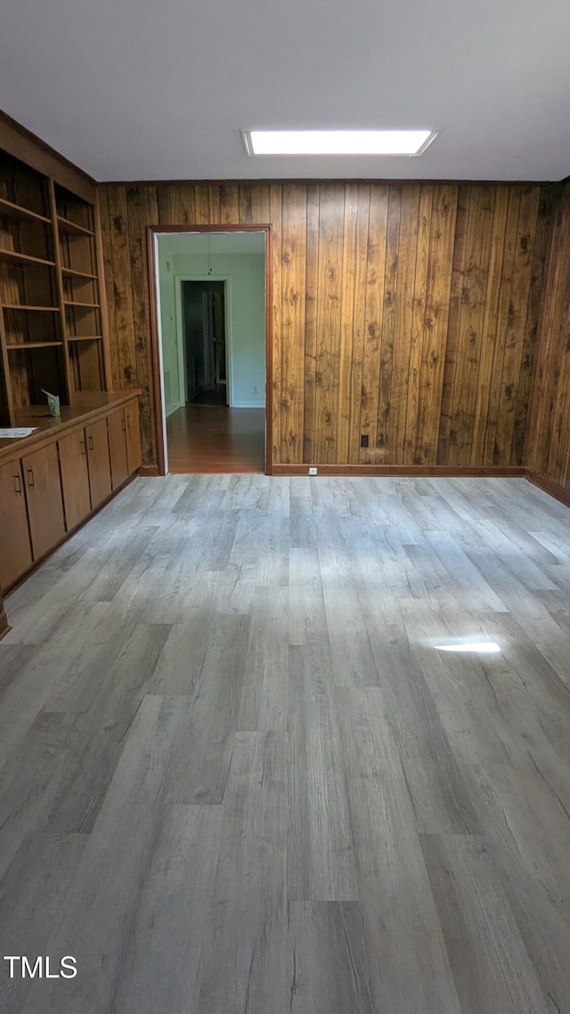 11636 Appaloosa Run W, Raleigh, NC 27613 - unfurnished living room with wooden walls and wood finished floors