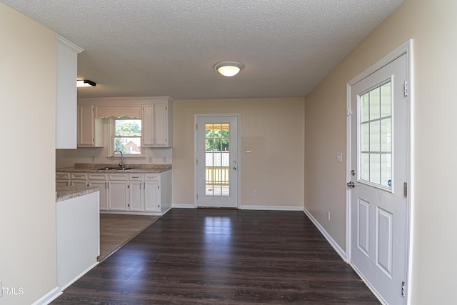 204 Mercer Ct, Goldsboro, NC 27530 - kitchen with dark wood finished floors, a textured ceiling, and white cabinets