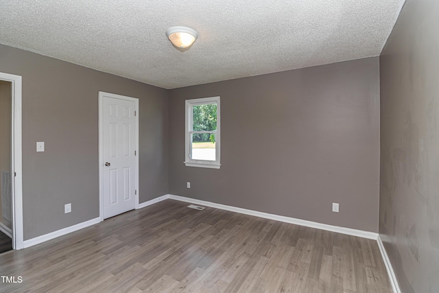 204 Mercer Ct, Goldsboro, NC 27530 - empty room with wood finished floors and a textured ceiling