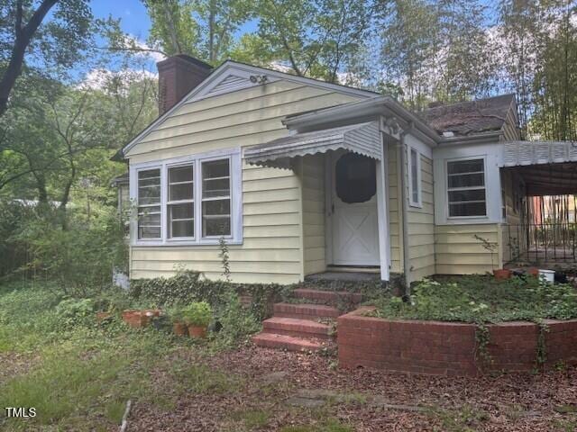 1414 Vickers Ave, Durham, NC 27707 - view of front of property featuring a chimney and an attached carport