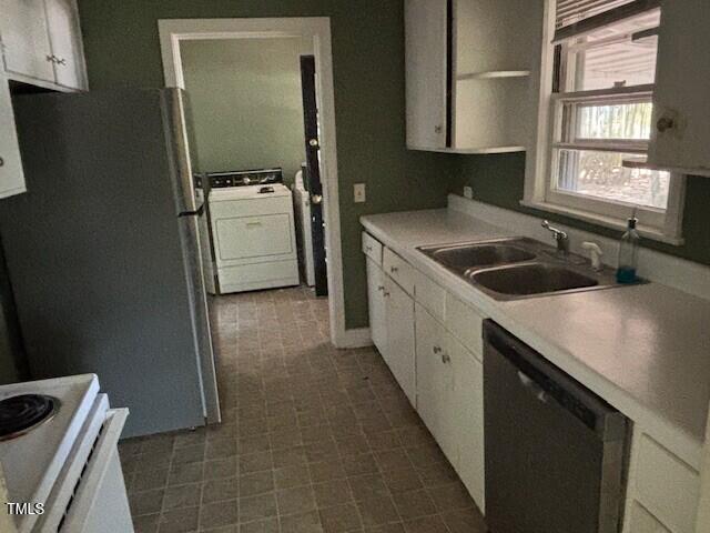 1414 Vickers Ave, Durham, NC 27707 - kitchen with washer / clothes dryer, black dishwasher, white cabinets, light countertops, and white range oven