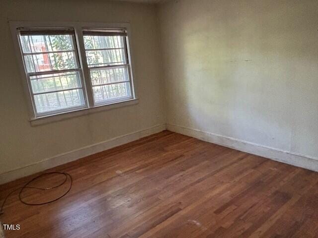1414 Vickers Ave, Durham, NC 27707 - spare room featuring wood finished floors and baseboards